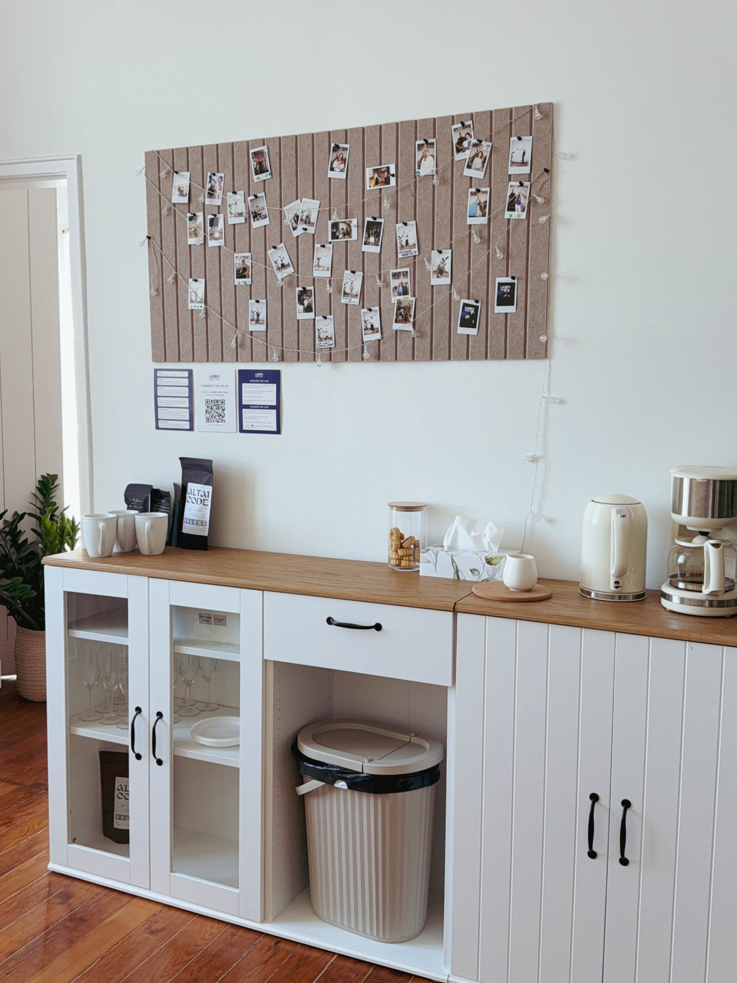 Coffee and tea corner of the Hub with kettle, coffee-maker, glassware and a polaroid board