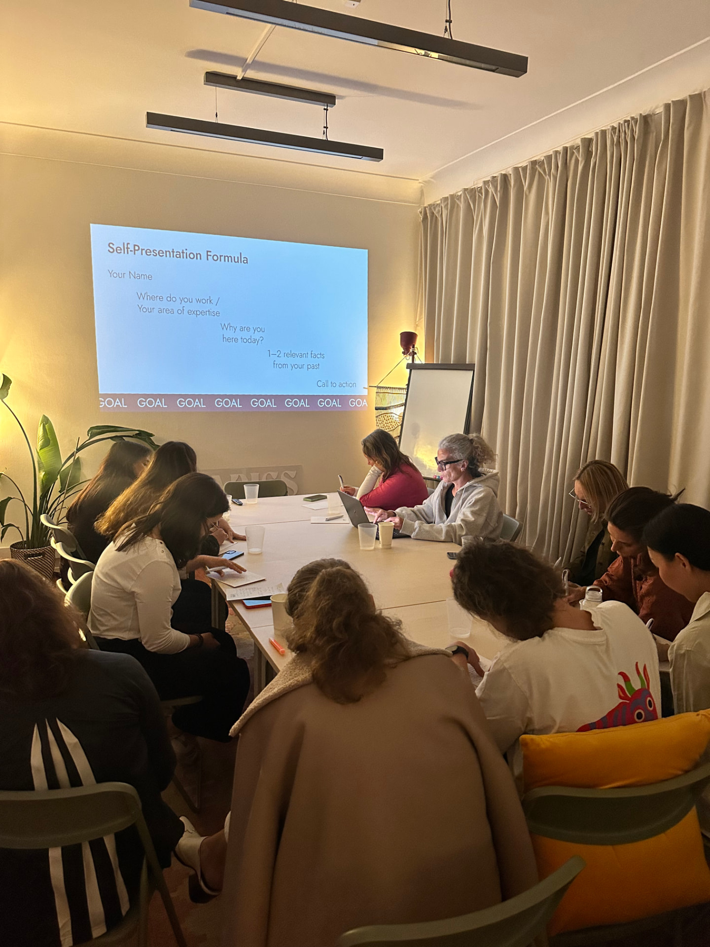 A workshop in progress around the table at the Hub