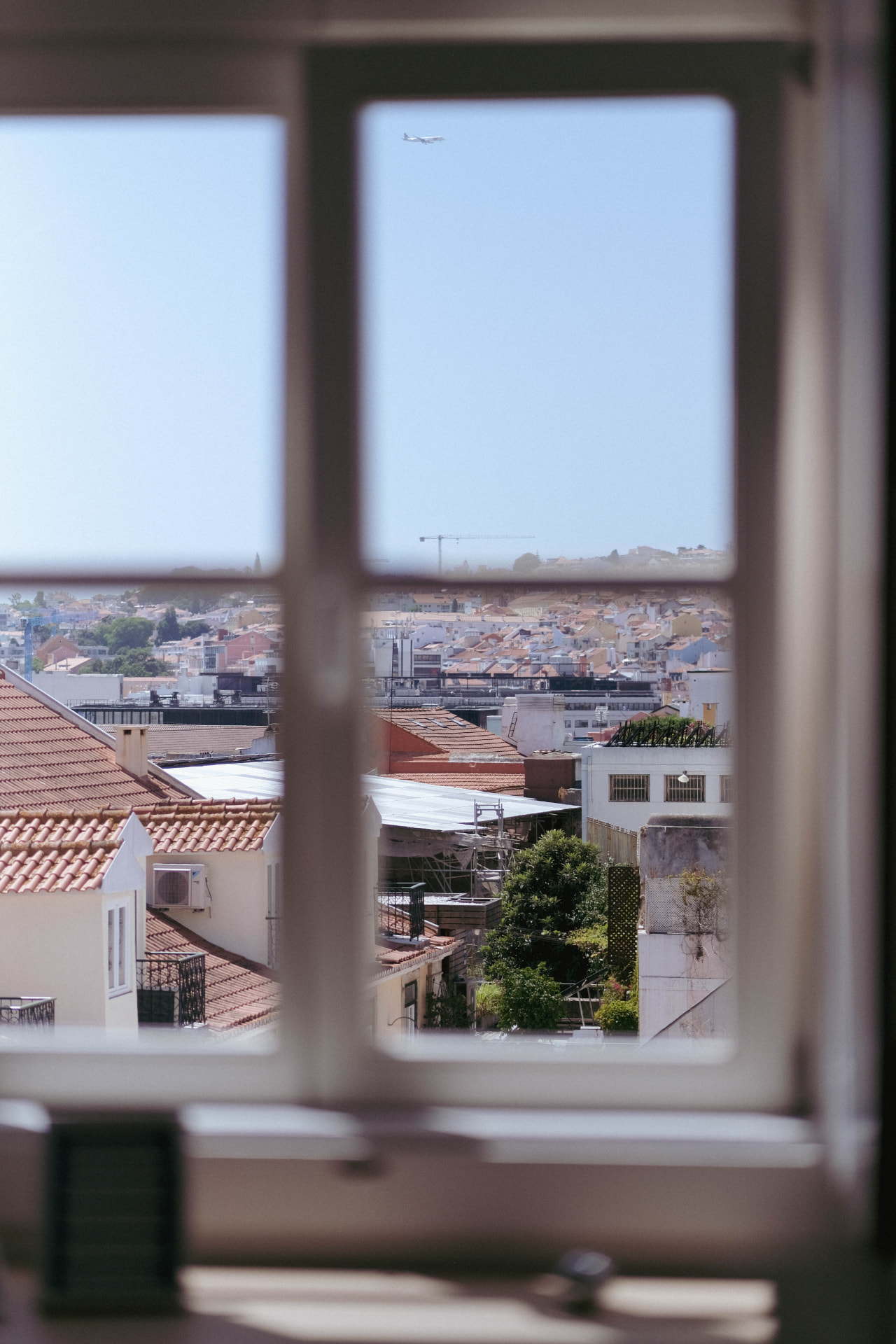 View through the Hub window over Lisbon rooftops towards the river